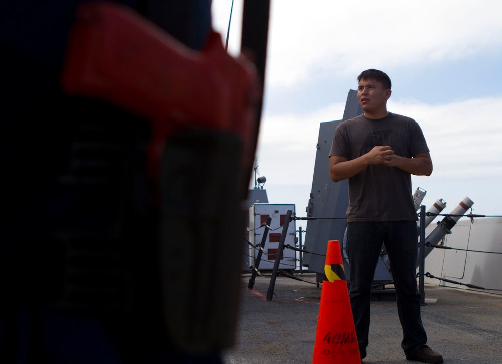 Suspicious Marines support sailors during protection drill