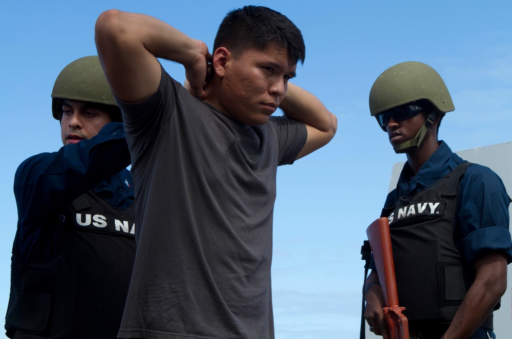 Suspicious Marines support sailors during protection drill