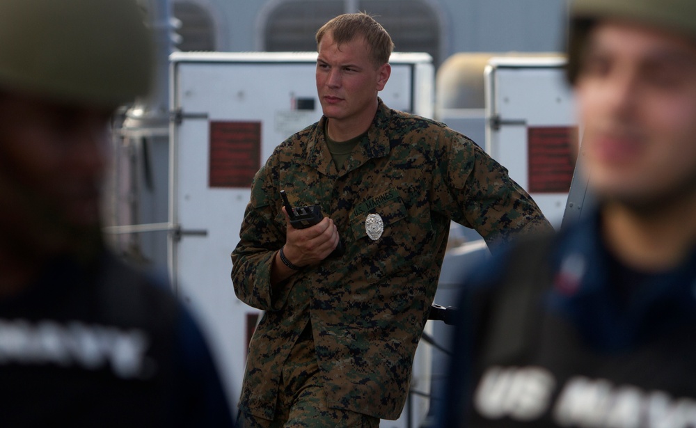 Suspicious Marines support sailors during protection drill