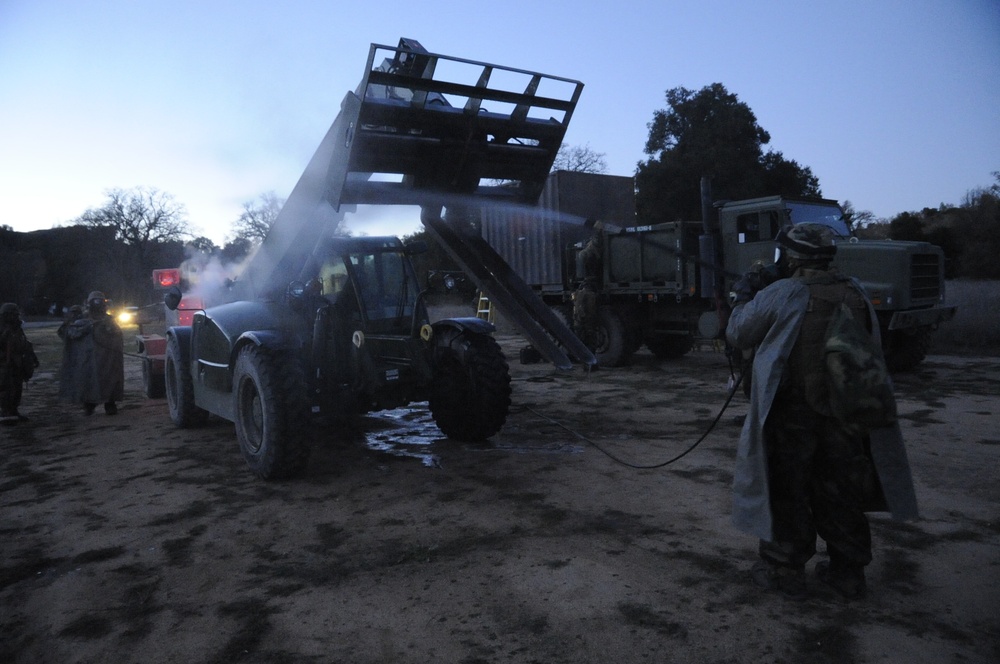 Seabee washes equipment after a chemical attack
