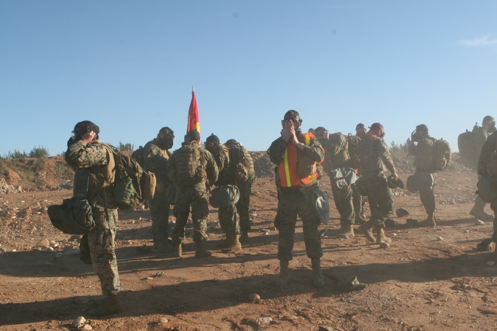 Headquarters and Headquarters Squadron hikes, trains with gas masks