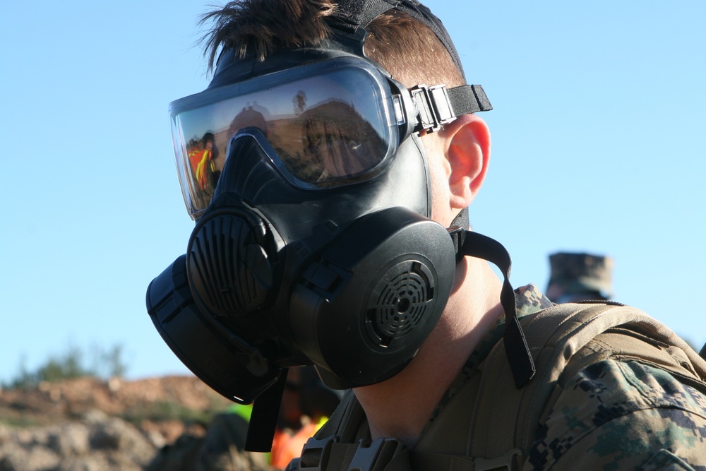 Headquarters and Headquarters Squadron hikes, trains with gas masks