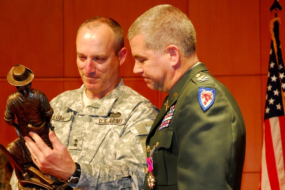 Maj. Gen. Gregory A. Lusk presents Col. Tom Harris with the Minuteman Statue