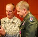 Maj. Gen. Gregory A. Lusk presents Col. Tom Harris with the Minuteman Statue