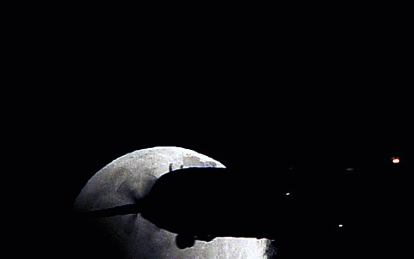 C-130 Hercules crosses paths with eclipsing moon