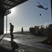 Marines move supplies off the elevator during vertical replenishment
