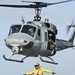 Sailor clears flight deck for UH-1N Huey