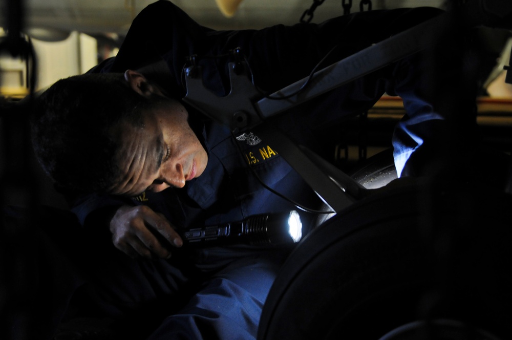 USS Anzio sailor inspects landing gear