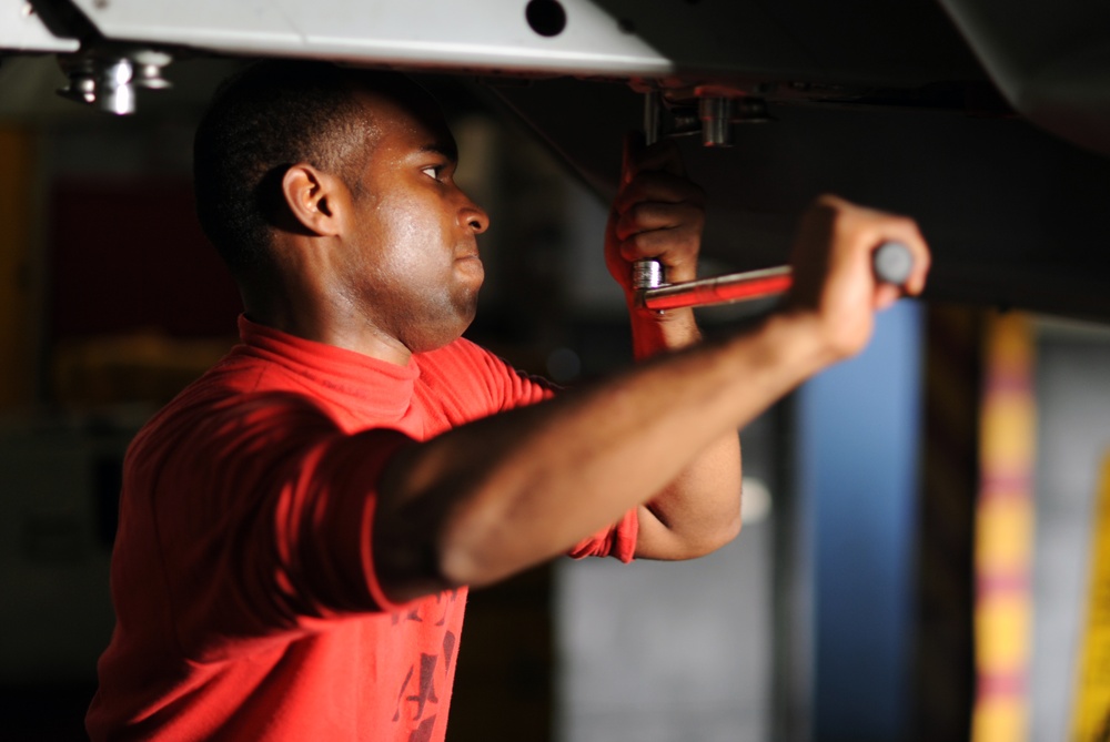 USS George H.W. Bush sailor tightens a bolt