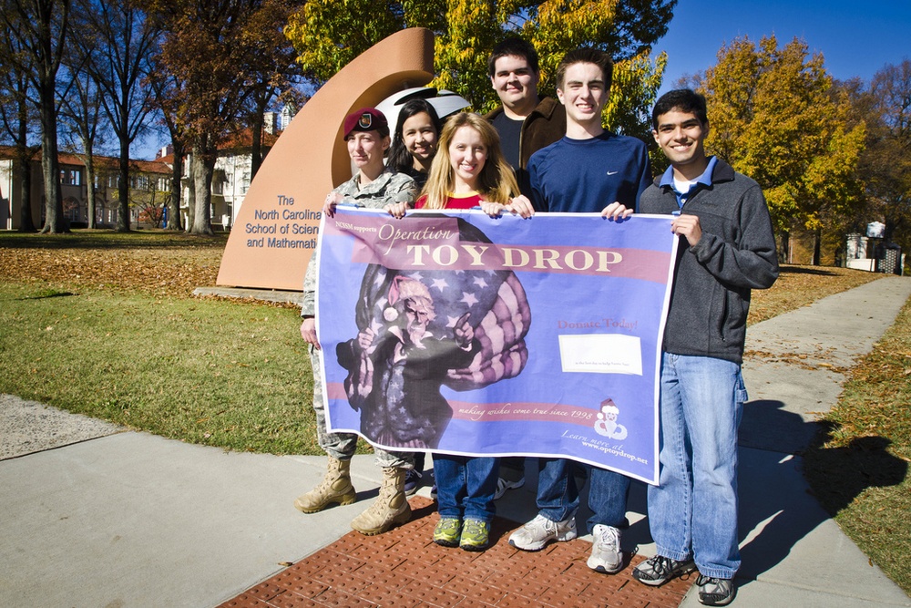 14th Annual Randy Oler Memorial Operation Toy Drop: From parachutes to calculus class, paratroopers, students team up to spread holiday cheer