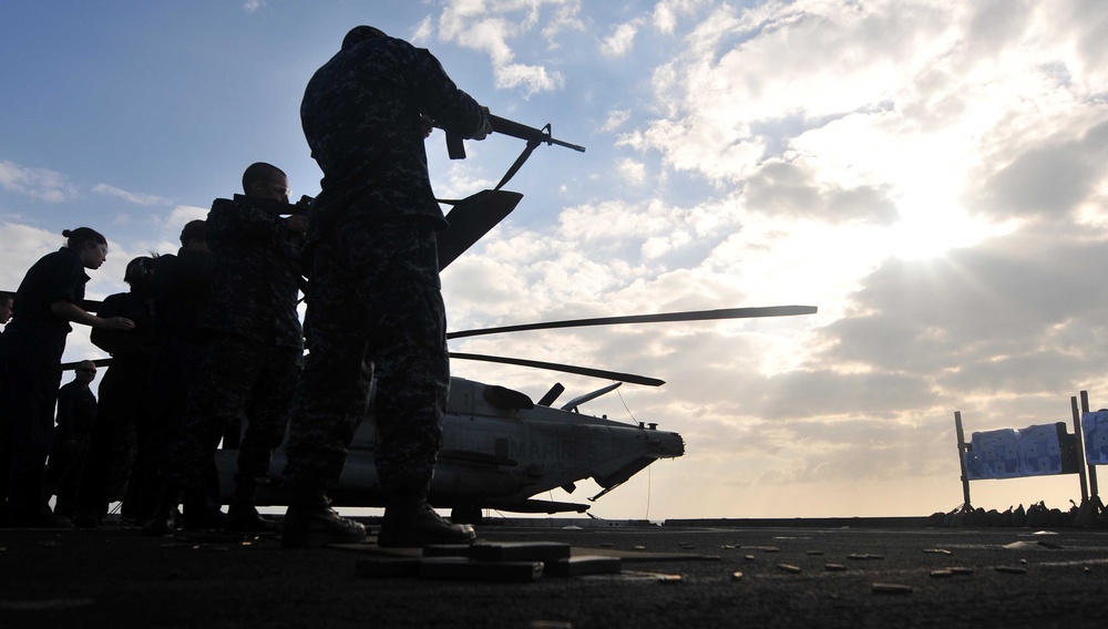 Sailors participate in live-fire qualification aboard USS Mesa Verde