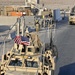 Last troops out of Iraq: Soldier holds American flag on convoy