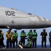 Sailor signals before launch aboard USS Carl Vinson