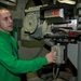 USS Enterprise sailor explais gear during tour