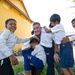 11 MEU Marine plays with children at school