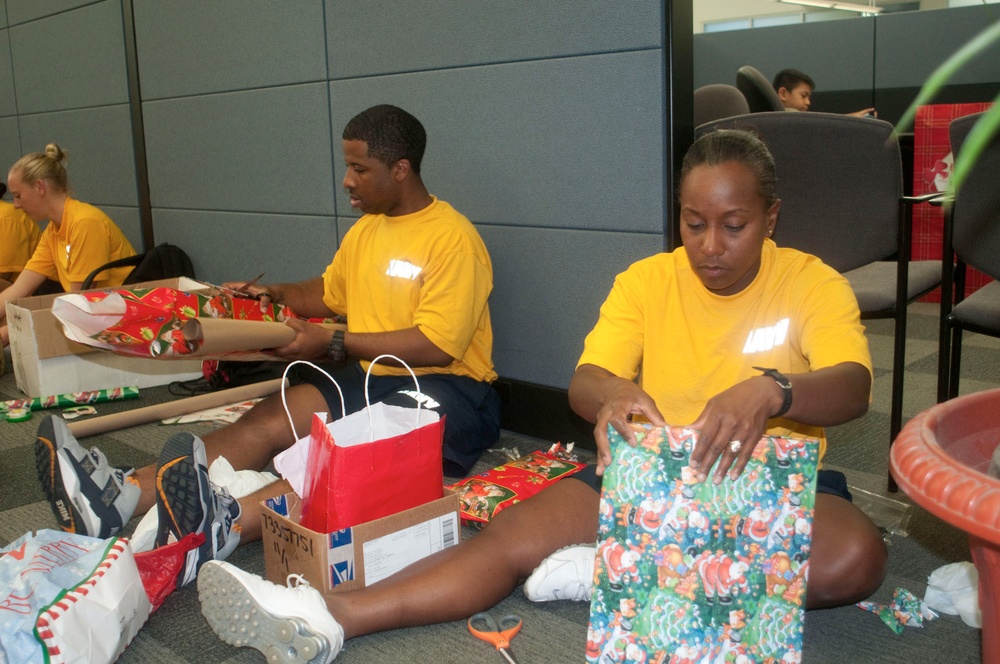 USS Chafee sailors wrap presents