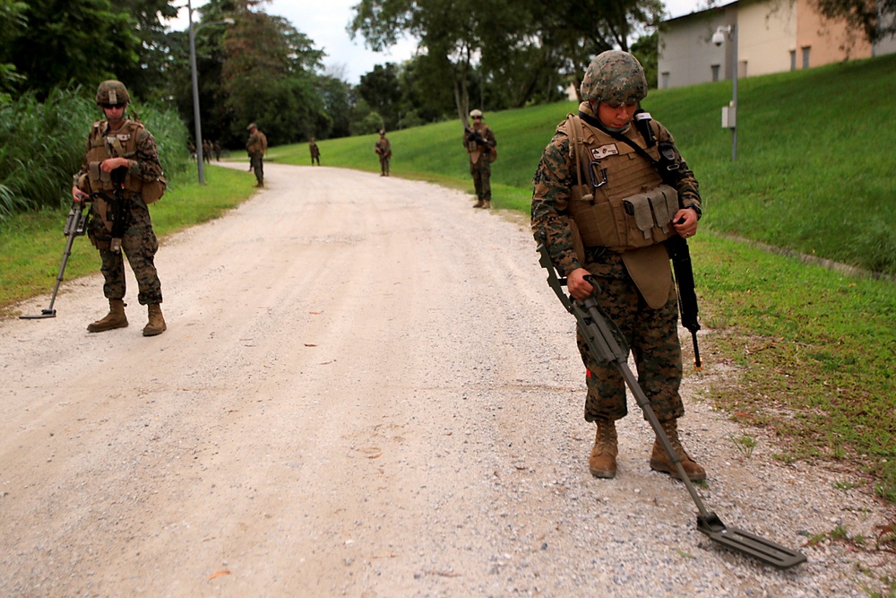 Marine uses metal detector during exercise