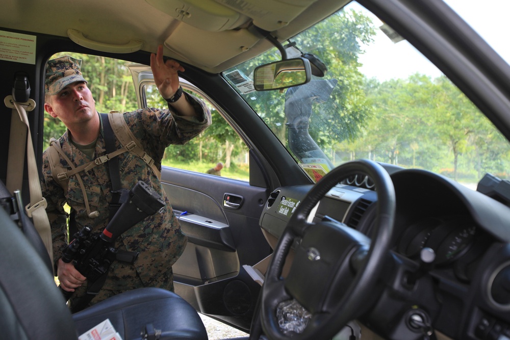 Marine inspects vehicle during exercise