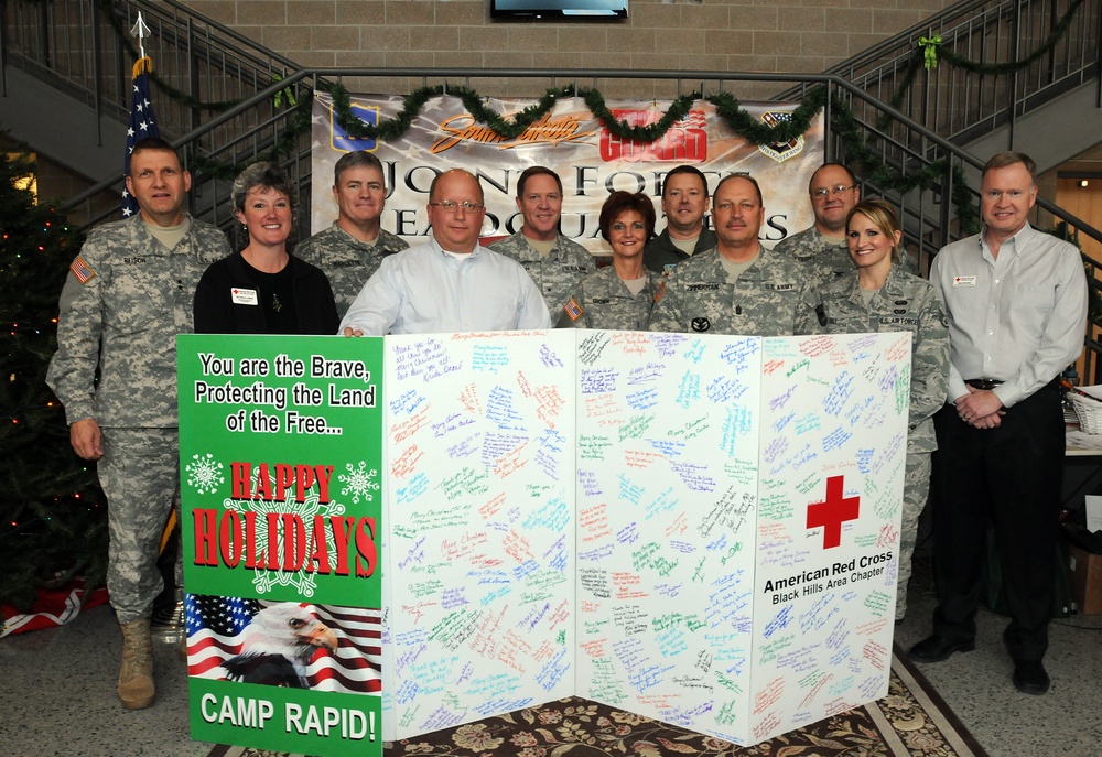 Red Cross presents Camp Rapid with Christmas card of appreciation