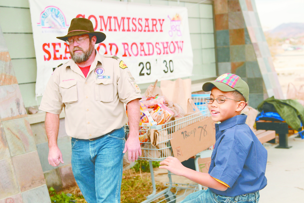 Boy, Cub Scouts serve community through can drive