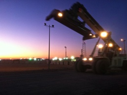 A connex pick and load vehicle drives to the loading area