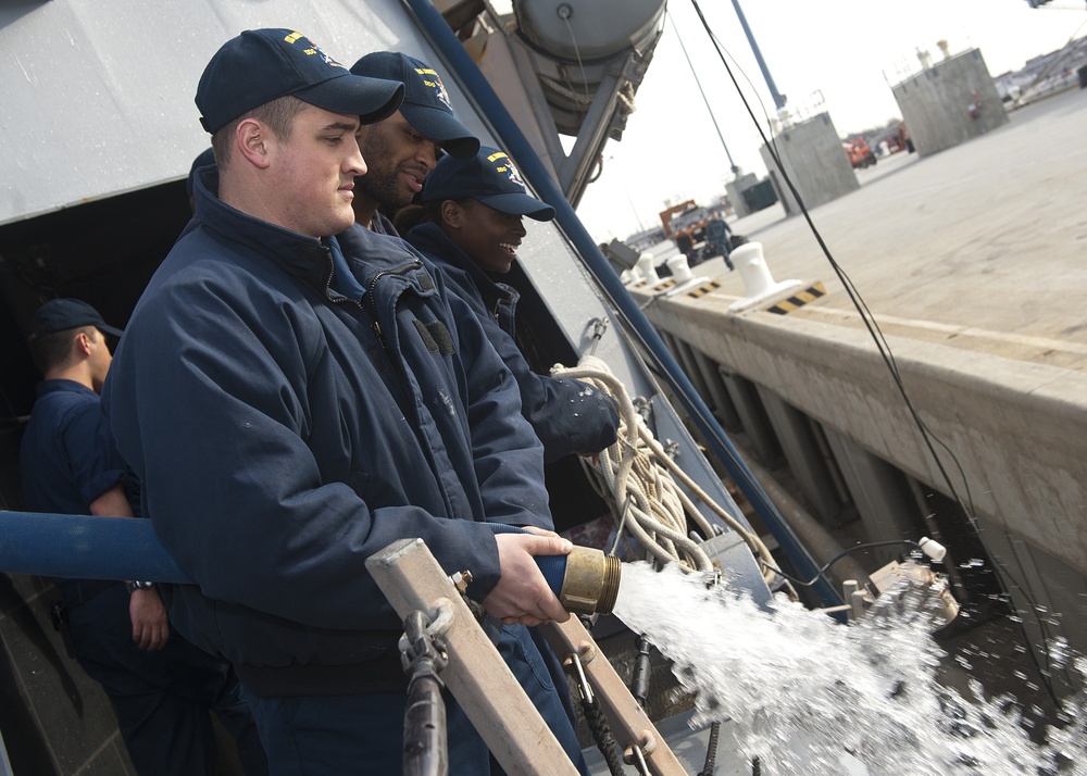 USS James E. Williams discharges potable water hose