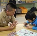 USS Cowpens sailor plays with a Japanese orphan