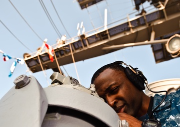 USS John C. Stennis sailor uses an alidade