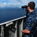 USS Abraham Lincoln sailor views island coast
