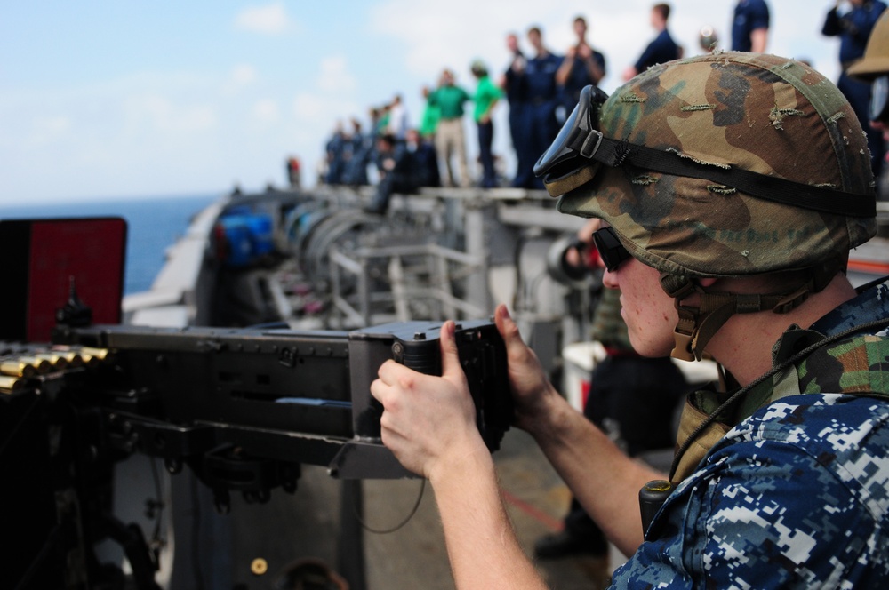USS Carl Vinson sailor fires machine gun