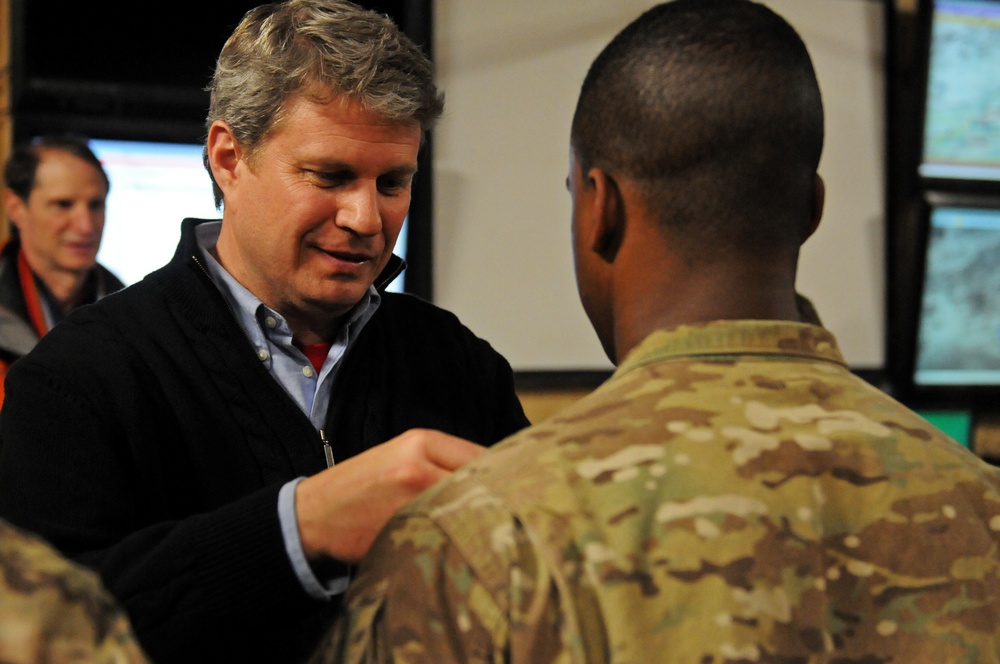 Michigan Representative Huizenga pins on a soldier's award