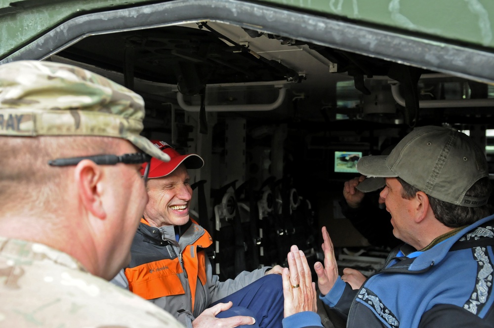 US senators share some laughs in the back of a Stryker in Regional Command (South)