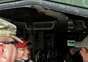 US senators share some laughs in the back of a Stryker in Regional Command (South)