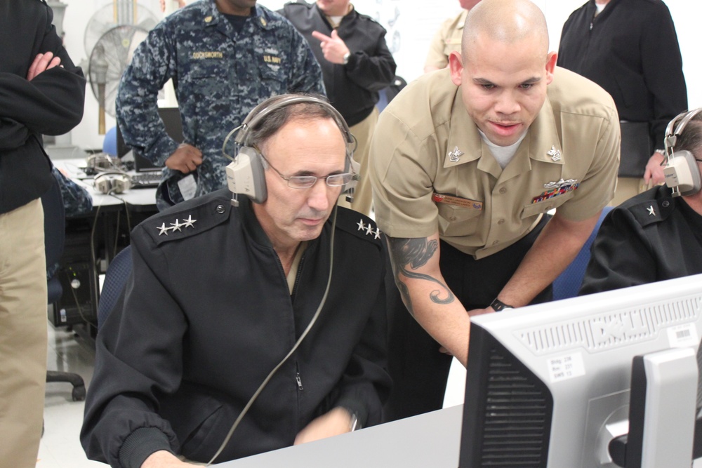 Instructor explains surface warfare officer course to Vice Adm. Buskirk