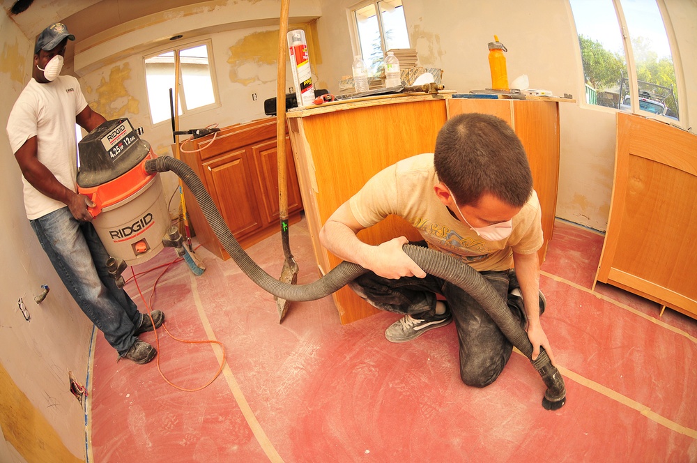 USS Boxer sailors vacuum during a community service project