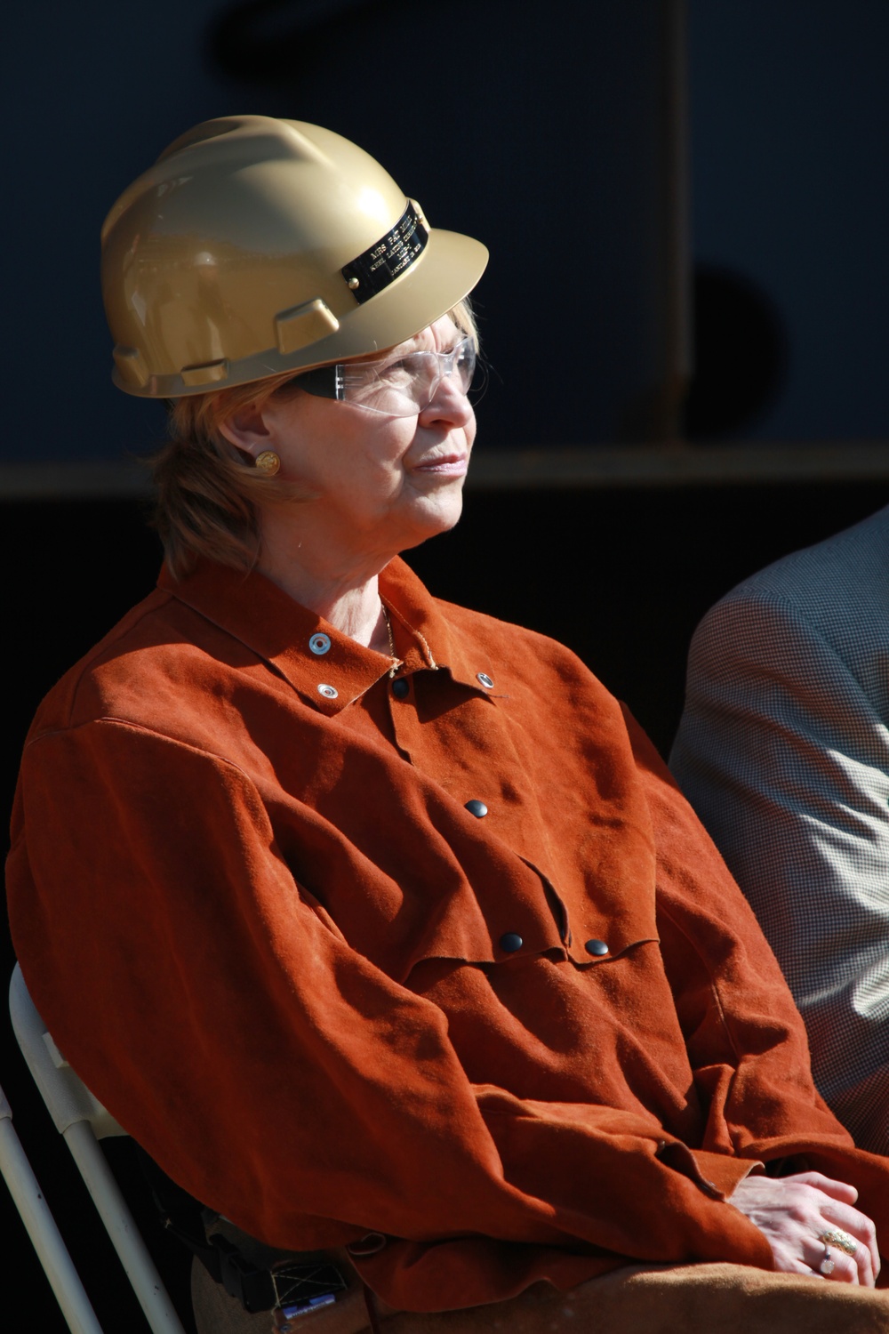 Honorary guest Pat Mills attends a Keel Laying Ceremony where she will brand her initials into one of Department of the Navy's newest Mobile Landing Platform