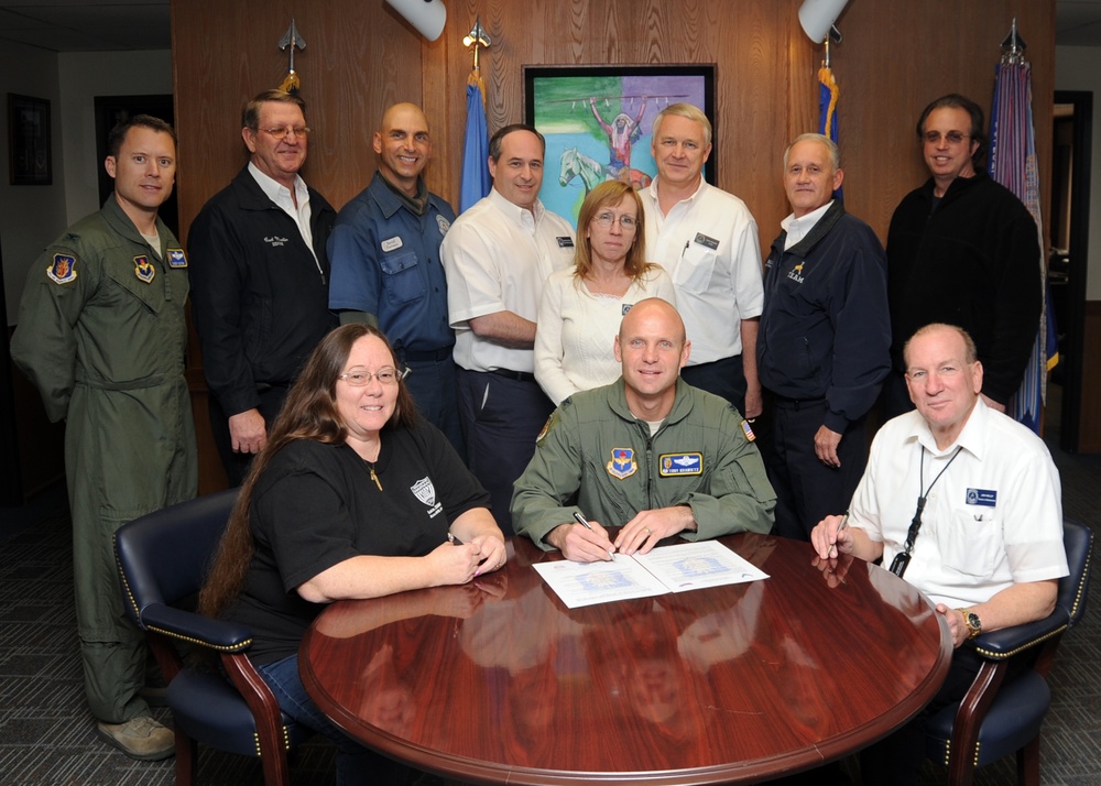 97th AMW commander signs volunteer contract