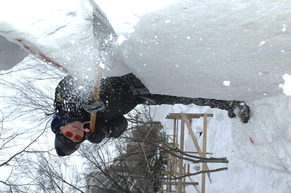 Navy Misawa sailors building 'Lone Sailor' snow sculpture