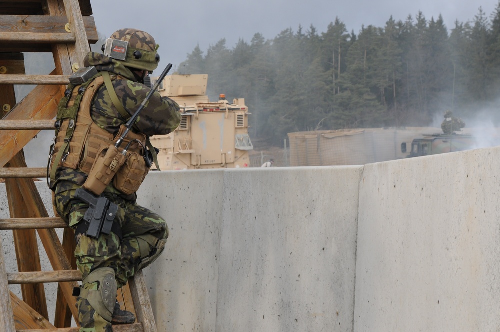Czech army soldier fires at enemy combatants during training exercise