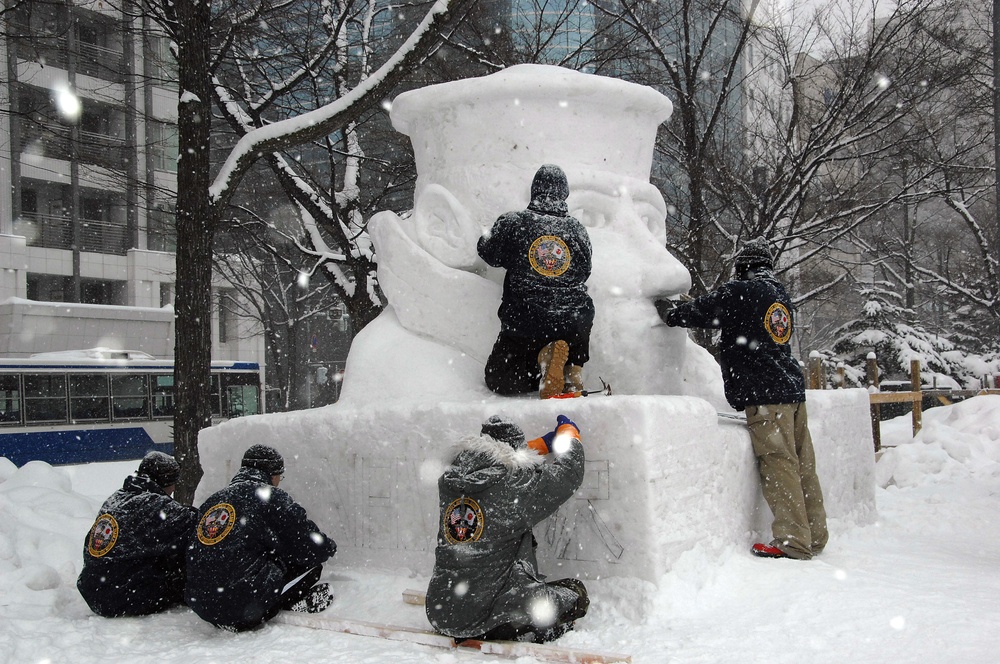 The Navy Misawa snow sculpture team get detail oriented