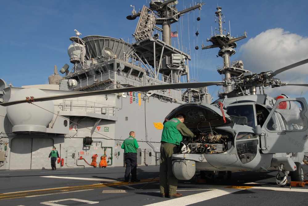 Air crewman performs pre-flight maintenance