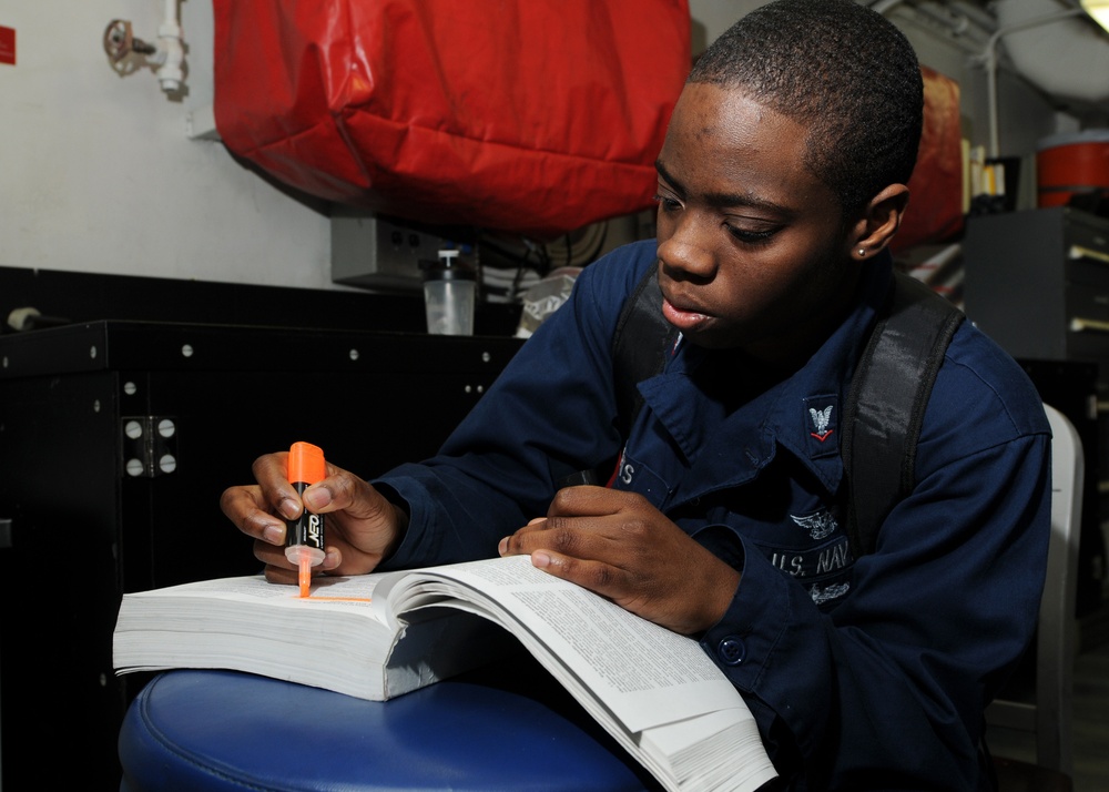 USS George H.W Bush sailor studies for exam
