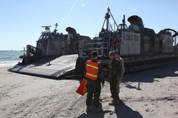 USS San Antonio sailors work with Marines