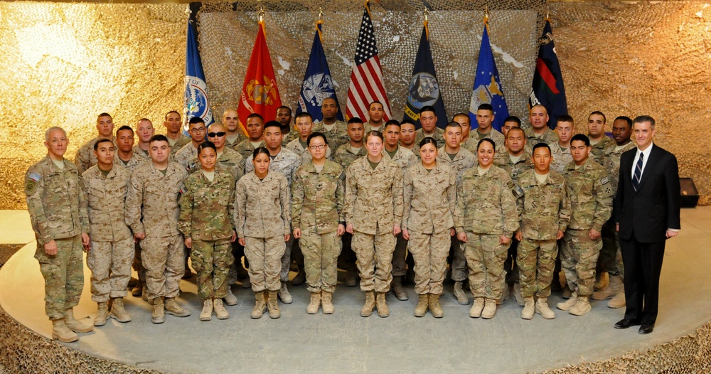 Maj. Gen. Huggins, Ambassador Olson take a photo with 36 service members, new American citizens