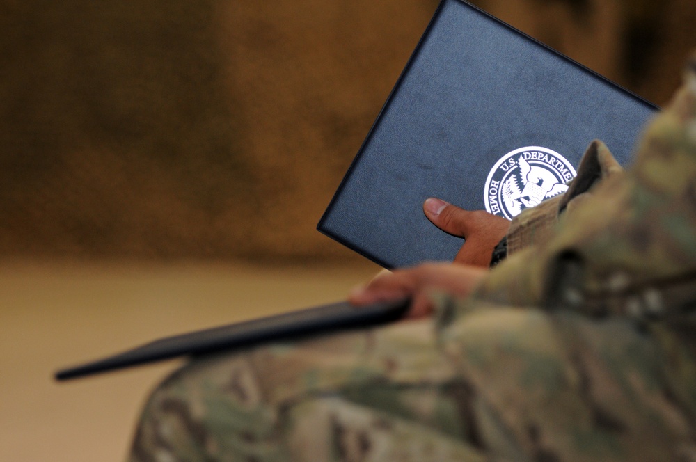 Newly naturalized soldier hold his certificate of citizenship
