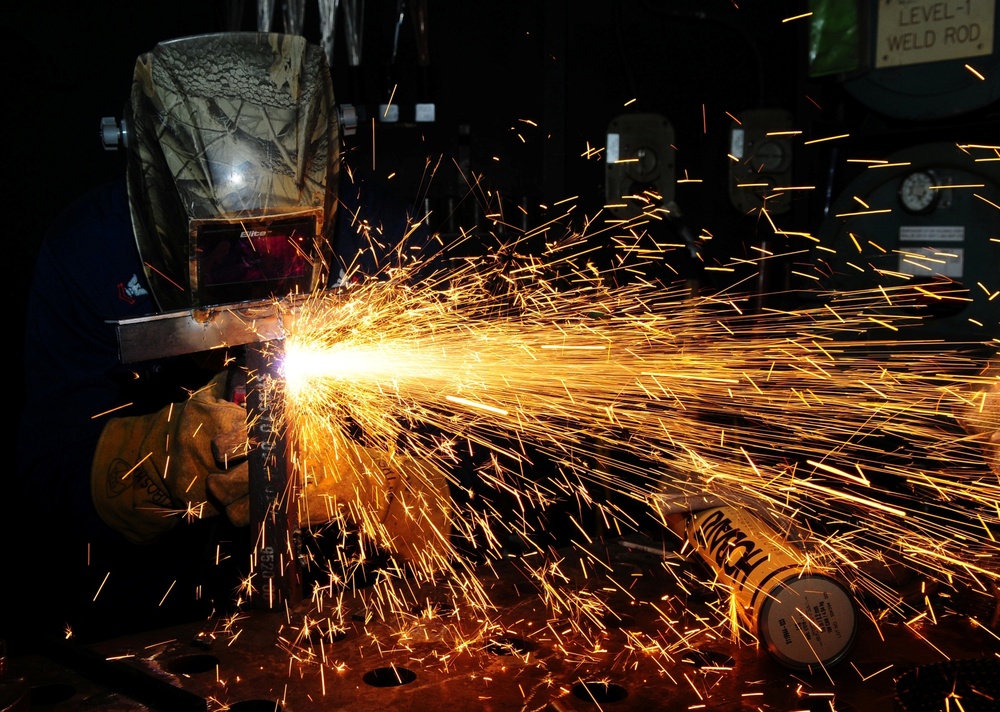 USS Abraham Lincoln sailor wields scrap metal