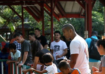 Service members interact with Thai patients