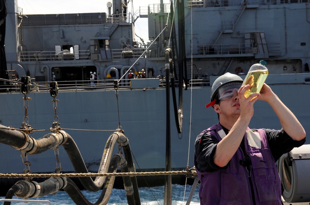 USS Momsen sailor checks fuel sample