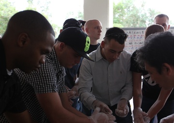 7th Communications Marines pound rice