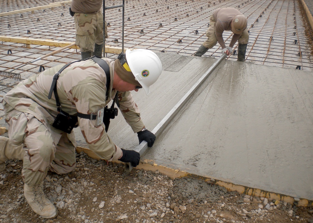 Seabee works on concrete at Forward Operating Base Pasab